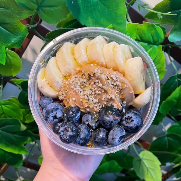 A Big Island Bowls acai bowl with bananas, blueberries, peanut butter, and hemp seeds.
