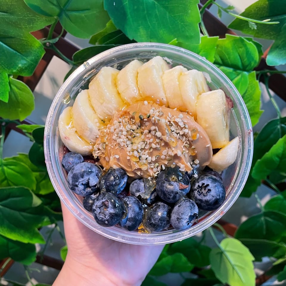 A Big Island Bowls acai bowl with bananas, blueberries, peanut butter, and hemp seeds.