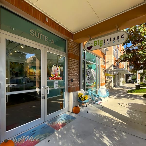 Exterior of Big Island Bowls, a healthy restaurant, with outdoor seating and a welcoming entrance.